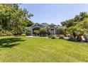 Gray one-story home with lush landscaping and palm trees at 5701 John Anderson Hwy, Flagler Beach, FL 32136