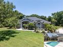 Well-maintained home with a spacious lawn and screened pool area at 5701 John Anderson Hwy, Flagler Beach, FL 32136