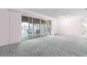 Bright living room featuring sliding glass doors to the porch at 10 Juniper Dr, Ormond Beach, FL 32176