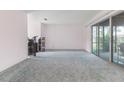Spacious living room with sliding glass doors and plush carpeting at 10 Juniper Dr, Ormond Beach, FL 32176