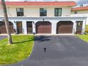 Charming condo building features well-maintained garages, colorful entry decor, and a lush lawn at 50 Ocean Palm Villa S, Flagler Beach, FL 32136