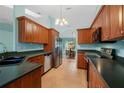 Spacious kitchen with dark wood cabinets and stainless steel appliances at 928 George Hecker Dr, South Daytona, FL 32119