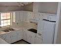 Bright kitchen features white cabinets, ample counter space, and a window at 6110 Everglades Dr, Port Orange, FL 32127