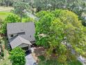 An aerial view showcasing the property's location with beautiful trees surrounding the residence at 100 Longspur Ct, Daytona Beach, FL 32119