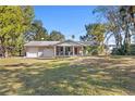 Single story home with attached garage and a manicured lawn at 1069 Indigo Rd, Ormond Beach, FL 32174