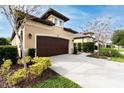 Two-story house with brown garage door, driveway, and landscaping at 3242 Bailey Ann Dr, Ormond Beach, FL 32174