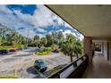 View from condo balcony showcasing parking lot and lush landscape at 640 N Nova Rd # 212, Ormond Beach, FL 32174