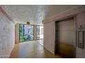 Condo hallway with elevator and window offering natural light at 640 N Nova Rd # 212, Ormond Beach, FL 32174