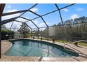 Inviting screened pool and spa with tranquil lake views at 10 Ocean Pines Dr, Ormond Beach, FL 32174