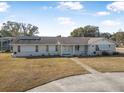 Single-story home with circular driveway and large backyard at 1102 Rolling Acres Dr, Deland, FL 32720