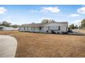 Single-story home with solar panels and a large grassy yard at 1102 Rolling Acres Dr, Deland, FL 32720