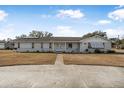 Brick home with a spacious yard and circular driveway at 1102 Rolling Acres Dr, Deland, FL 32720