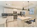 Modern kitchen with stainless steel appliances and an island at 4741 Clock Tower Dr # 105, Kissimmee, FL 34746