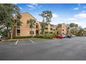 Condo building with parking and landscaping in a sunny setting at 1401 S Palmetto Ave # 618, Daytona Beach, FL 32114