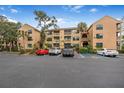 Front view of condo building showcasing its light color and parking at 1401 S Palmetto Ave # 618, Daytona Beach, FL 32114