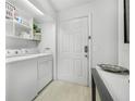 Bright laundry room with washer, dryer, and shelving at 1401 S Palmetto Ave # 618, Daytona Beach, FL 32114