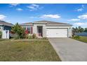 One-story home with a two-car garage, landscaped lawn, and attractive curb appeal at 1702 Myrtlebrooke Dr, Edgewater, FL 32141