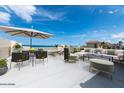 Rooftop terrace with ocean view, outdoor furniture, and umbrella at 3072 Ocean Shore Blvd, Ormond Beach, FL 32176