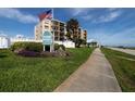 Ocean House Condominiums exterior view, featuring landscaping and signage at 2222 Ocean Shore Blvd # 102B, Ormond Beach, FL 32176