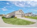 New home showcasing side elevation, landscaping, and a privacy fence at 4247 Little Owl Ln, Kissimmee, FL 34746
