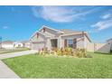 New construction home with curb appeal, well manicured lawn and two-car garage at 4247 Little Owl Ln, Kissimmee, FL 34746