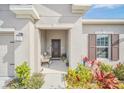 Covered front porch with seating area, adding to the home's curb appeal at 4247 Little Owl Ln, Kissimmee, FL 34746
