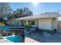 Exterior home view includes front entrance, garage, landscaping, and the pool is shown in a smaller inset at 5700 E Fort King St, Ocala, FL 34470