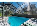 Relaxing screened-in pool with patio furniture at 5700 E Fort King St, Ocala, FL 34470