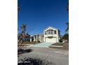 Two-story house with a large garage and manicured lawn at 105 Barrier Isle Dr, Ormond Beach, FL 32176