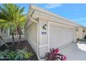 Home's side view showcasing garage and landscaping at 1221 Harwick Ln, Ormond Beach, FL 32174