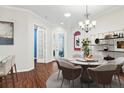 Bright dining room features a round table with seating for six and a chandelier at 1311 Hansberry Ln, Ormond Beach, FL 32174