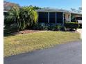 Landscaped mobile home with covered carport and spacious yard at 215 Rue De Paresse, Tavares, FL 32778