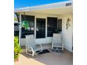 Relaxing front porch with two comfy chairs, perfect for enjoying the Florida sun at 215 Rue De Paresse, Tavares, FL 32778