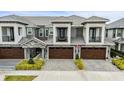 Three townhouses with dark brown garage doors and lush landscaping at 2840 Isles Way, New Smyrna Beach, FL 32168