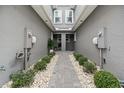 Shared walkway between townhouses with landscaping and rock at 2840 Isles Way, New Smyrna Beach, FL 32168