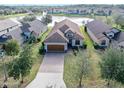 Stunning aerial view of a house and community near a lake at 3189 Connemara Dr, Ormond Beach, FL 32174