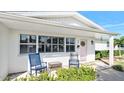 Inviting front porch with rocking chairs and pink door at 35 Country Club Dr, Ormond Beach, FL 32176