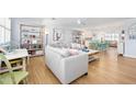 Light and airy living room with light gray couch and built-in shelving at 35 Country Club Dr, Ormond Beach, FL 32176