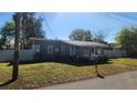 Gray house with a green lawn and white fence at 623 Unabelle Ave, Holly Hill, FL 32117