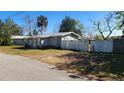 Gray house with a white picket fence and small yard at 623 Unabelle Ave, Holly Hill, FL 32117