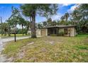 Tan house with a screened porch and a yard at 627 Clark St, Daytona Beach, FL 32114