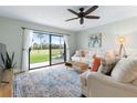 Cozy living room featuring a comfortable sofa, stylish rug, and scenic view of the outdoors at 66 Ocean Palm Villa S, Flagler Beach, FL 32136