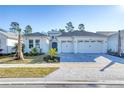 Charming two-story house with a three-car garage and manicured lawn at 707 Hang Loose Way, Daytona Beach, FL 32124