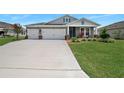 Two-story house with a two-car garage and a long driveway at 2840 Monaghan Dr, Ormond Beach, FL 32174