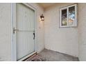White front door with glass panel and exterior light fixture at 3548 Forest Branch Dr # C, Port Orange, FL 32129