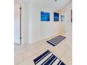 Bright hallway with tile floors and beach-themed wall art at 4641 S Atlantic Ave # 2010, Port Orange, FL 32127