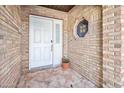 Front entry with white door and brick exterior at 56 Winding Creek Way, Ormond Beach, FL 32174