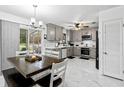 Modern kitchen with gray cabinets, white quartz countertops, and marble flooring at 89 Hickory Hills Cir, Ormond Beach, FL 32174