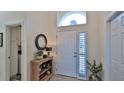 Bright entryway with wood console table, mirror, and access to laundry room at 1453 Sunningdale Ln, Ormond Beach, FL 32174