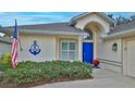 Front view of a house with blue door and nautical decor at 1453 Sunningdale Ln, Ormond Beach, FL 32174